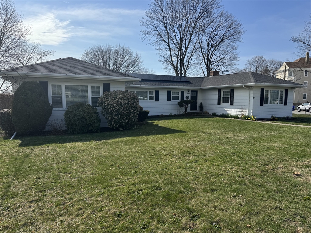 a front view of a house with a garden
