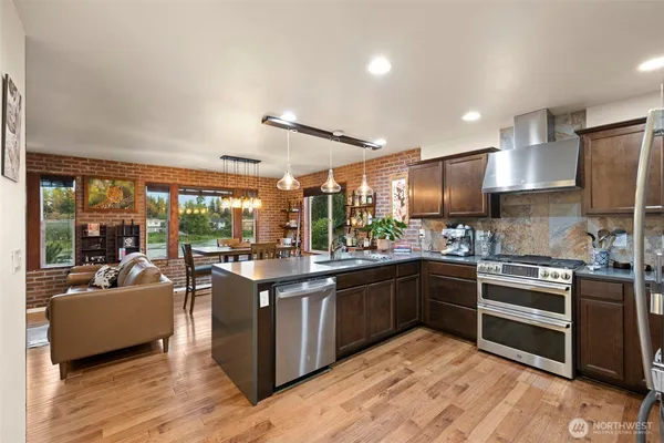 a kitchen with stainless steel appliances granite countertop a stove and a sink