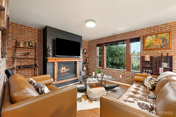 a living room with fireplace furniture and a flat screen tv