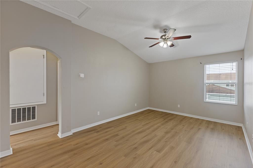506 Rainbow Springs Loop Groveland, FL 34736 - Photo 13 of 30 a view of empty room with wooden floor and fan