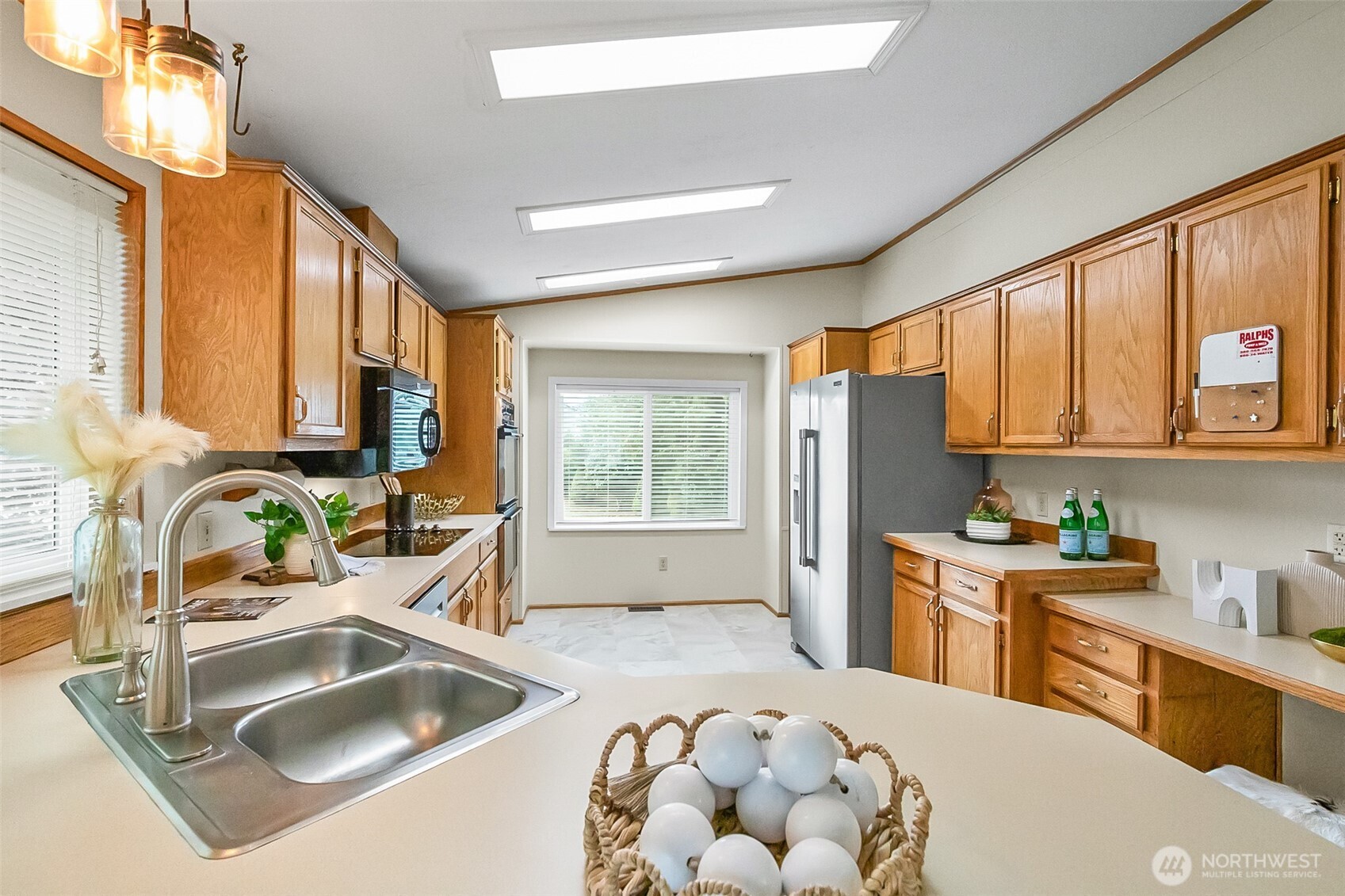 12928 Sultan Basin Road Sultan, WA 98294 - Photo 11 of 39 a kitchen with sink refrigerator and large window