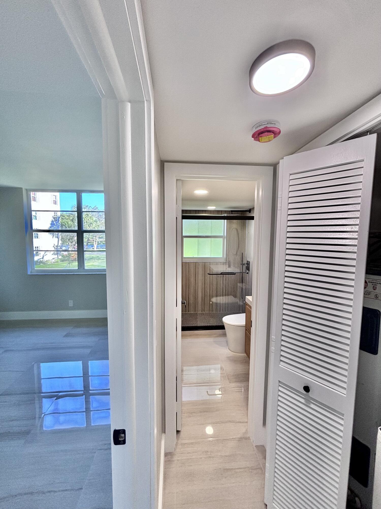 545 Oaks Lane, Unit 201 Pompano Beach, FL 33069 - Photo 16 of 22 a view of a hallway and a livingroom with furniture