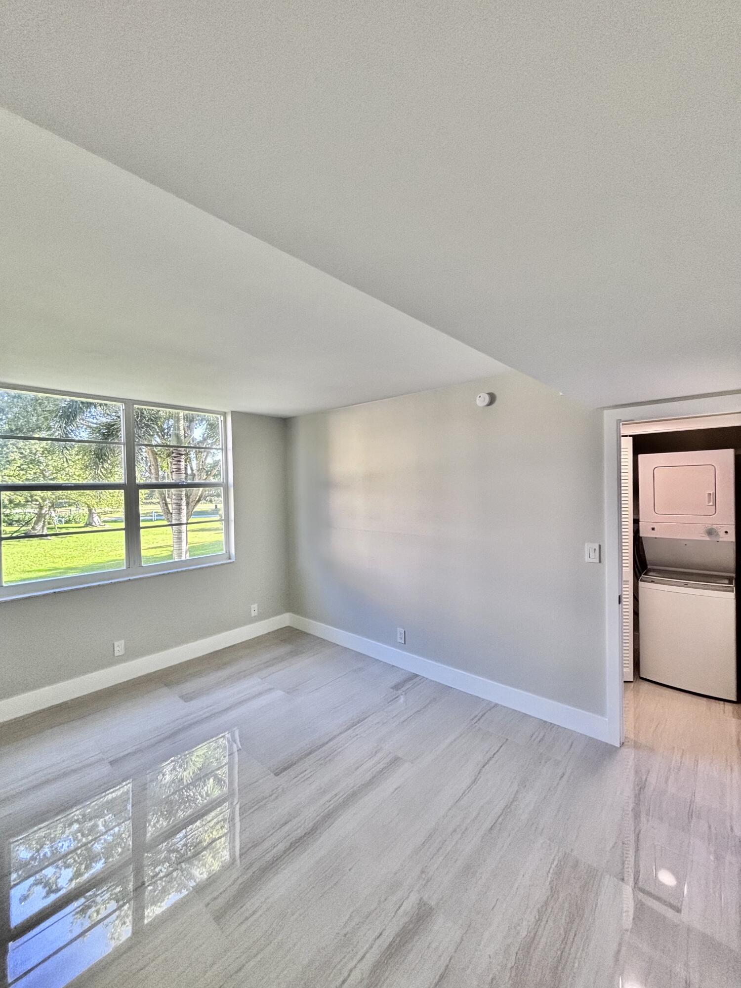 545 Oaks Lane, Unit 201 Pompano Beach, FL 33069 - Photo 18 of 22 an empty room with window and mirror