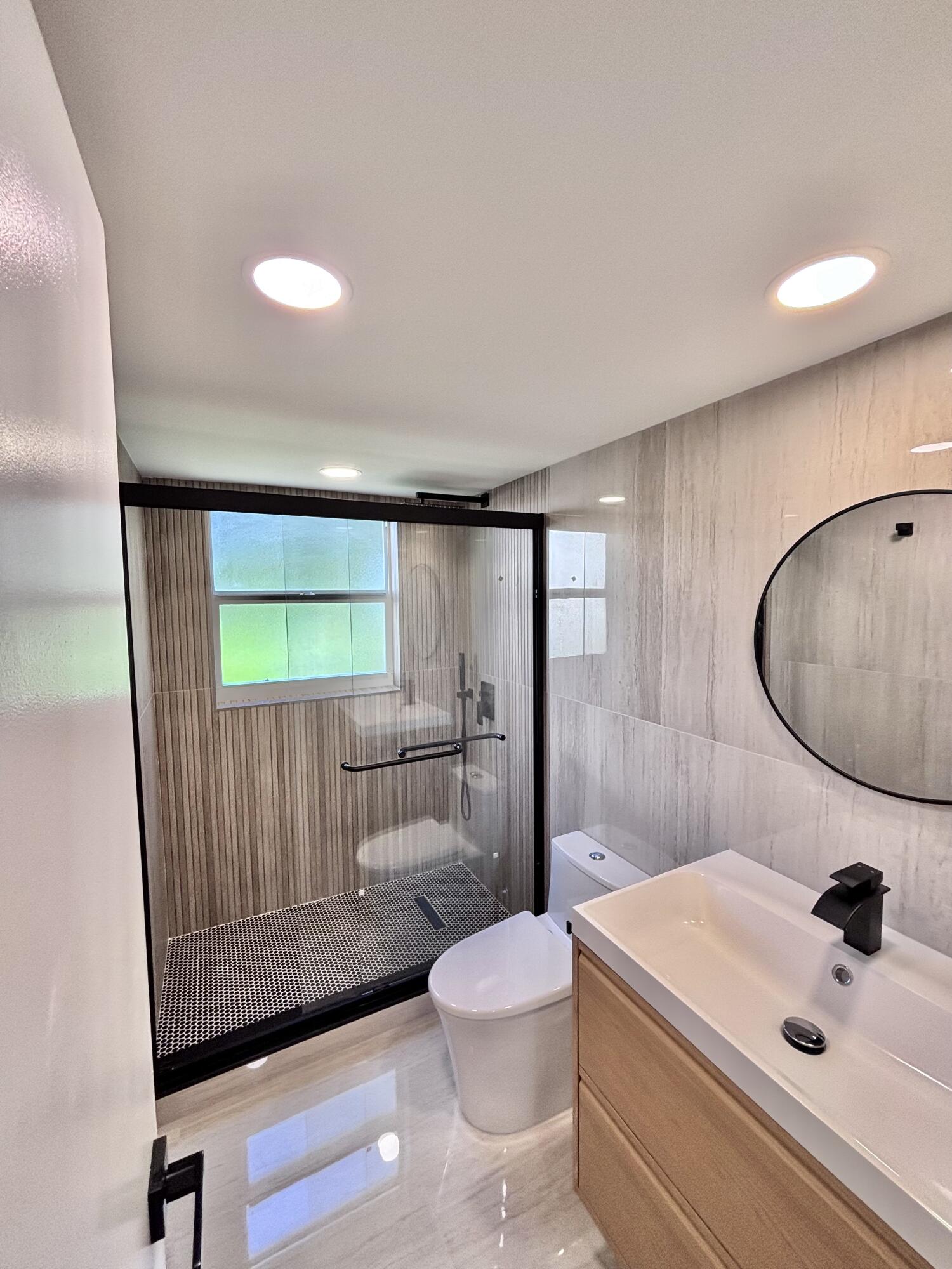 545 Oaks Lane, Unit 201 Pompano Beach, FL 33069 - Photo 19 of 22 a bathroom with a sink a toilet and shower