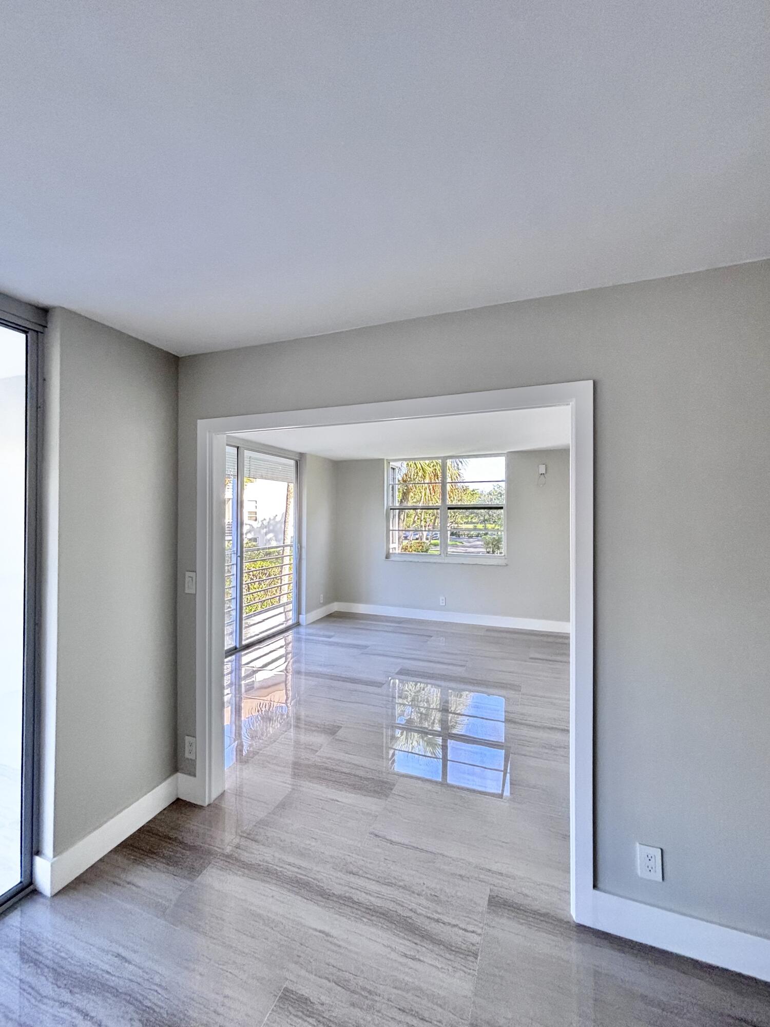 545 Oaks Lane, Unit 201 Pompano Beach, FL 33069 - Photo 8 of 22 a view of a hallway with wooden floor