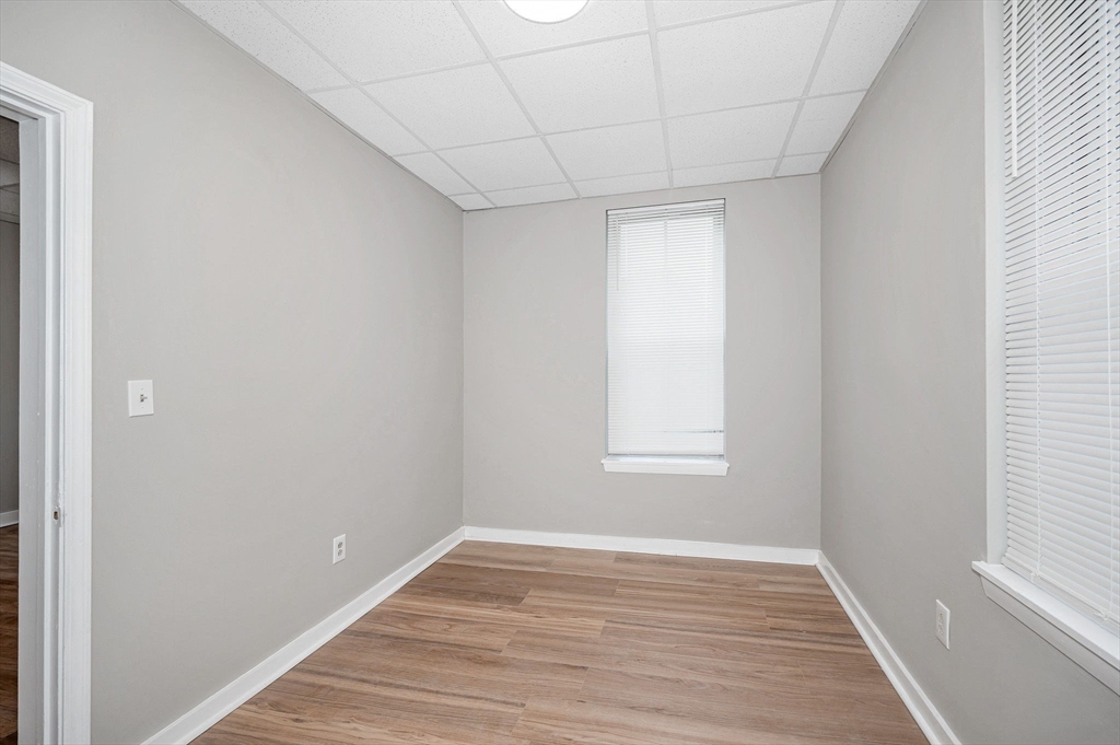 90 Appleton Street, Unit U:7 Lowell, MA 01852 - Photo 10 of 13 a view of empty room with wooden floor and fan