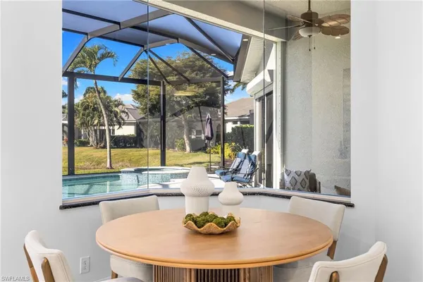 a dining room with furniture and a window
