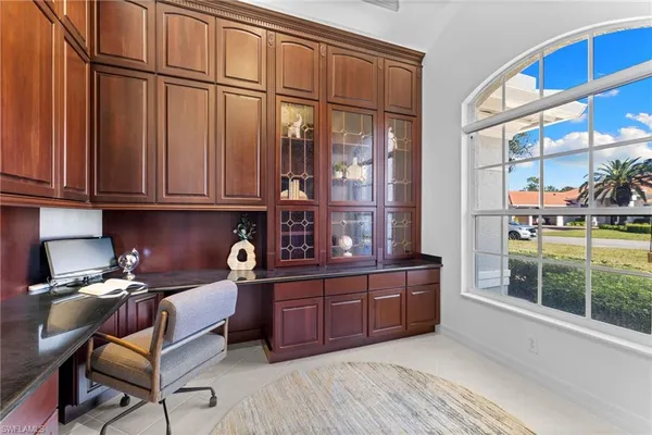 a kitchen with stainless steel appliances granite countertop a cabinets and outdoor view living room