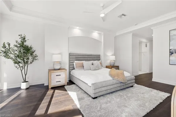 a bedroom with a bed and a potted plant