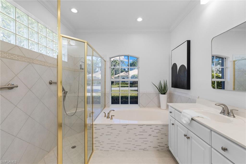 1624 Manchester Court Naples, FL 34109 - Photo 26 of 49 Bathroom featuring a garden tub, vanity, ornamental molding, a stall shower, and recessed lighting