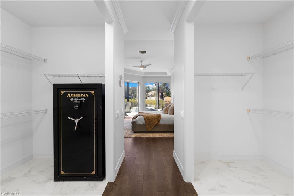 1624 Manchester Court Naples, FL 34109 - Photo 27 of 49 Walk in closet featuring a ceiling fan and marble look tiles