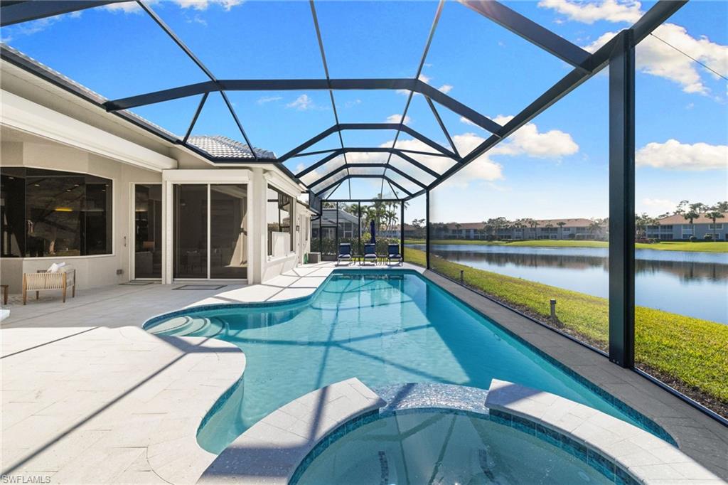 1624 Manchester Court Naples, FL 34109 - Photo 40 of 49 Integrated pool / hot tub featuring a sunroom, glass enclosure, a water view, and a patio area