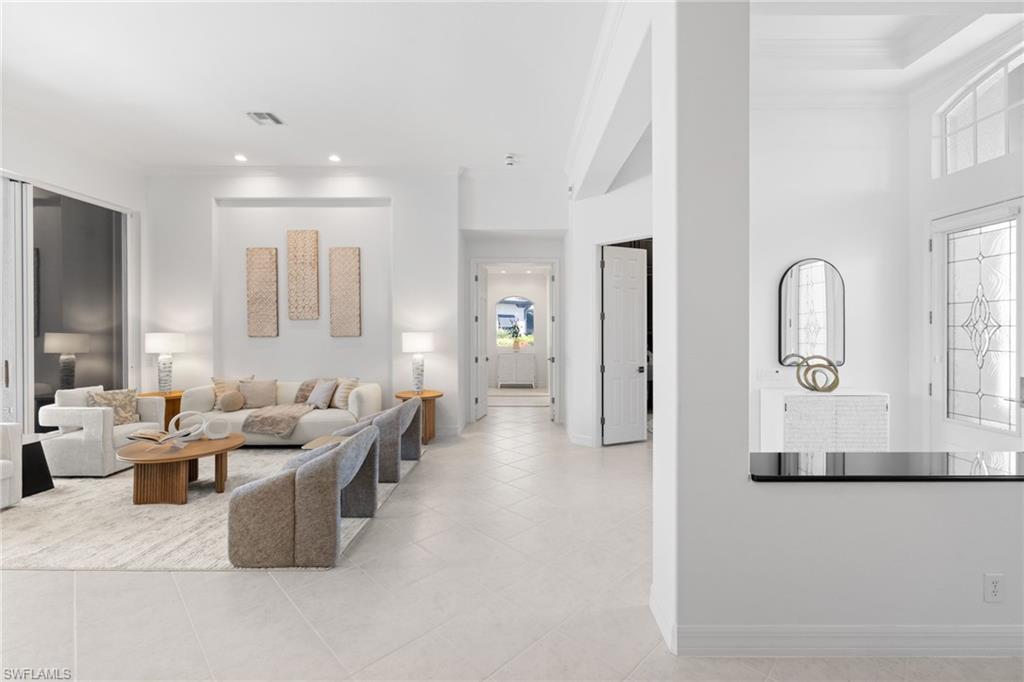 1624 Manchester Court Naples, FL 34109 - Photo 4 of 49 Living room with crown molding and recessed lighting