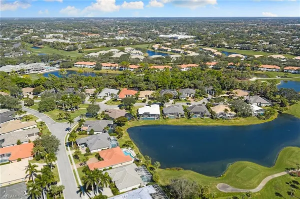 an aerial view of residential houses with outdoor space and lake view