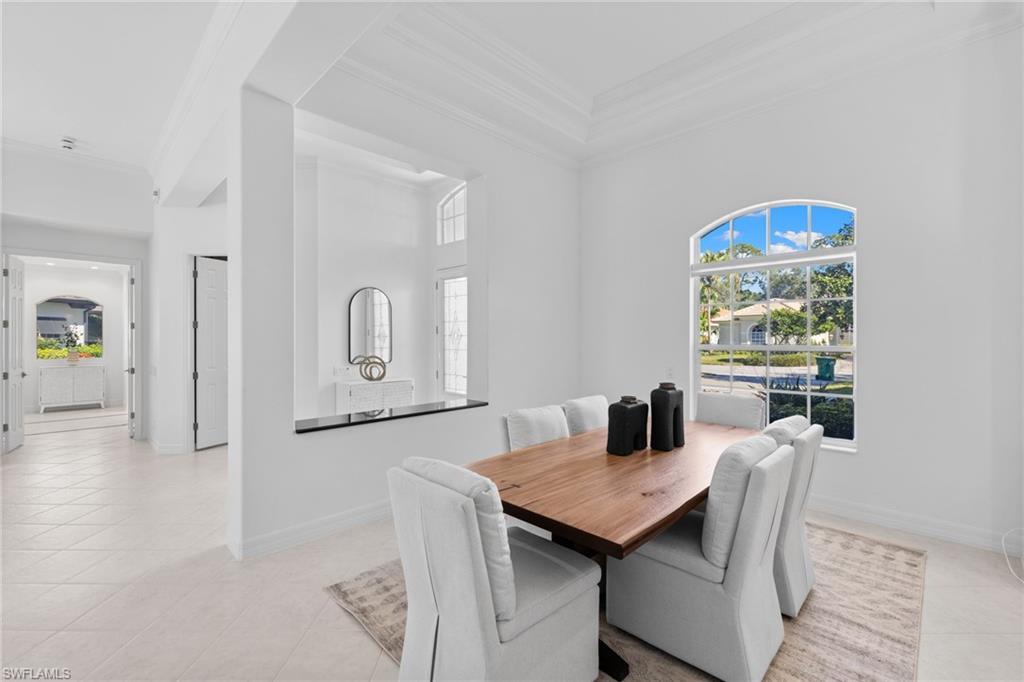 1624 Manchester Court Naples, FL 34109 - Photo 6 of 49 Dining room featuring ornamental molding, healthy amount of natural light, and light tile patterned flooring