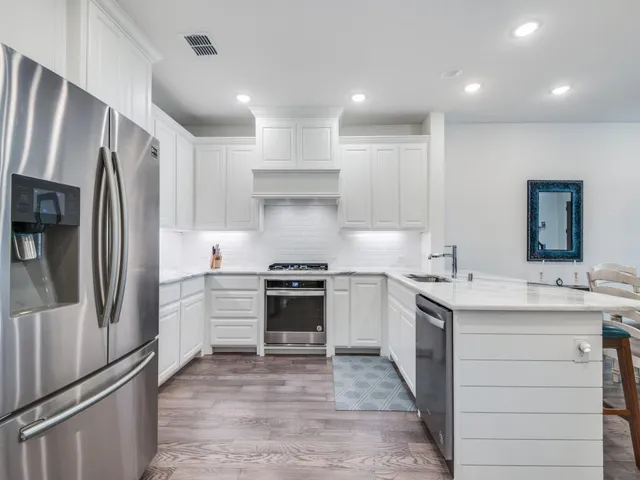 a kitchen with a sink stainless steel appliances and cabinets