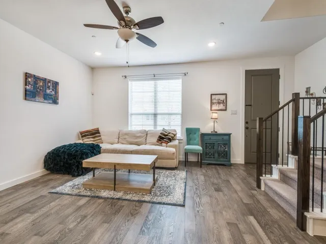 a living room with furniture and a wooden floor
