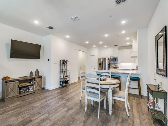 a dining room with furniture and wooden floor