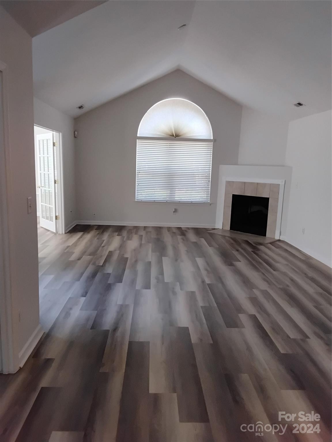 817 Ledgestone Court Fort Mill, SC 29708 - Photo 14 of 36 an empty room with wooden floor cabinet and windows