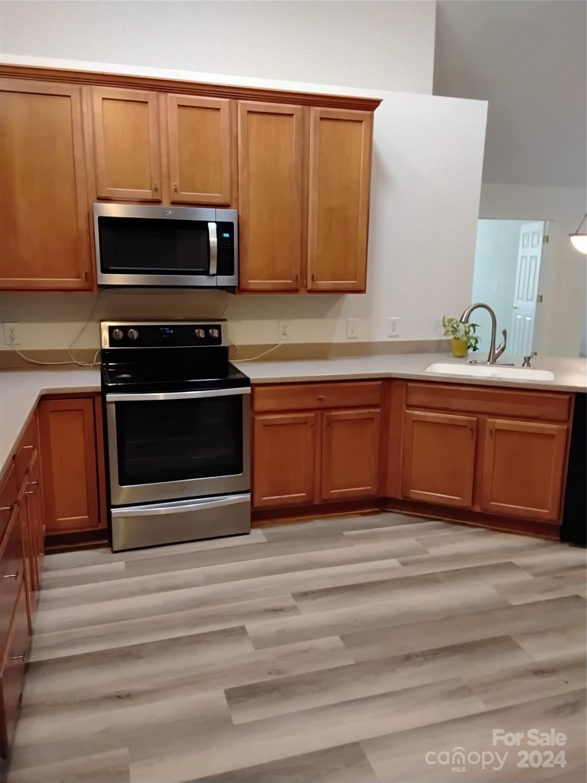 817 Ledgestone Court Fort Mill, SC 29708 - Photo 20 of 36 a living room with stainless steel appliances wooden cabinets and a stove top oven