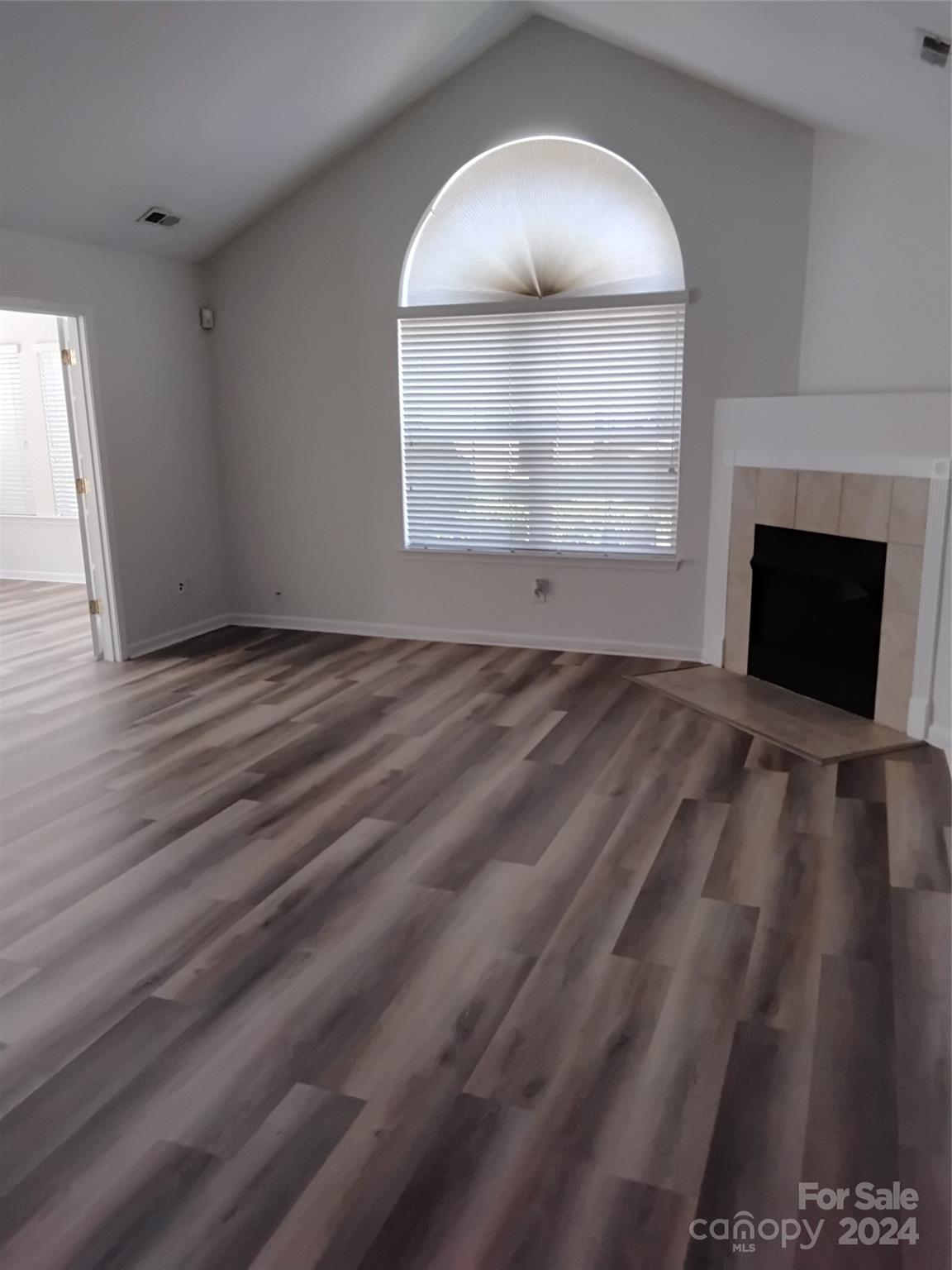 817 Ledgestone Court Fort Mill, SC 29708 - Photo 24 of 36 an empty room with windows and fireplace