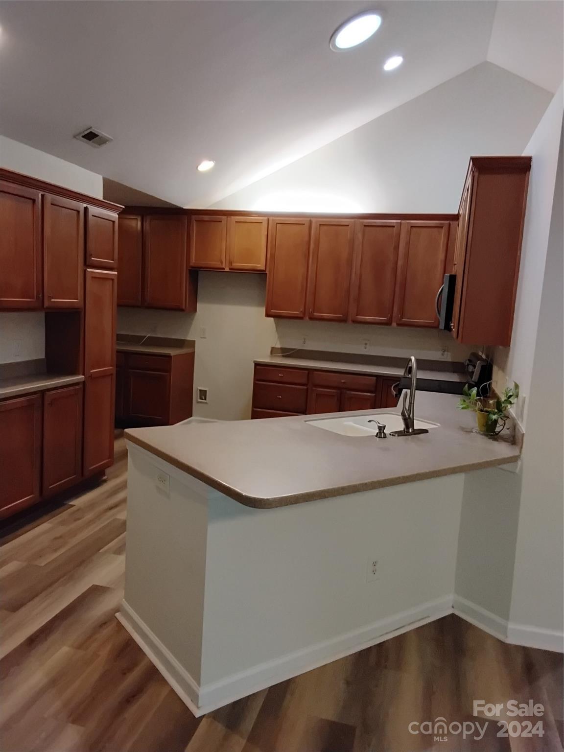 817 Ledgestone Court Fort Mill, SC 29708 - Photo 7 of 36 a kitchen with kitchen island granite countertop wooden cabinets a sink and a stove