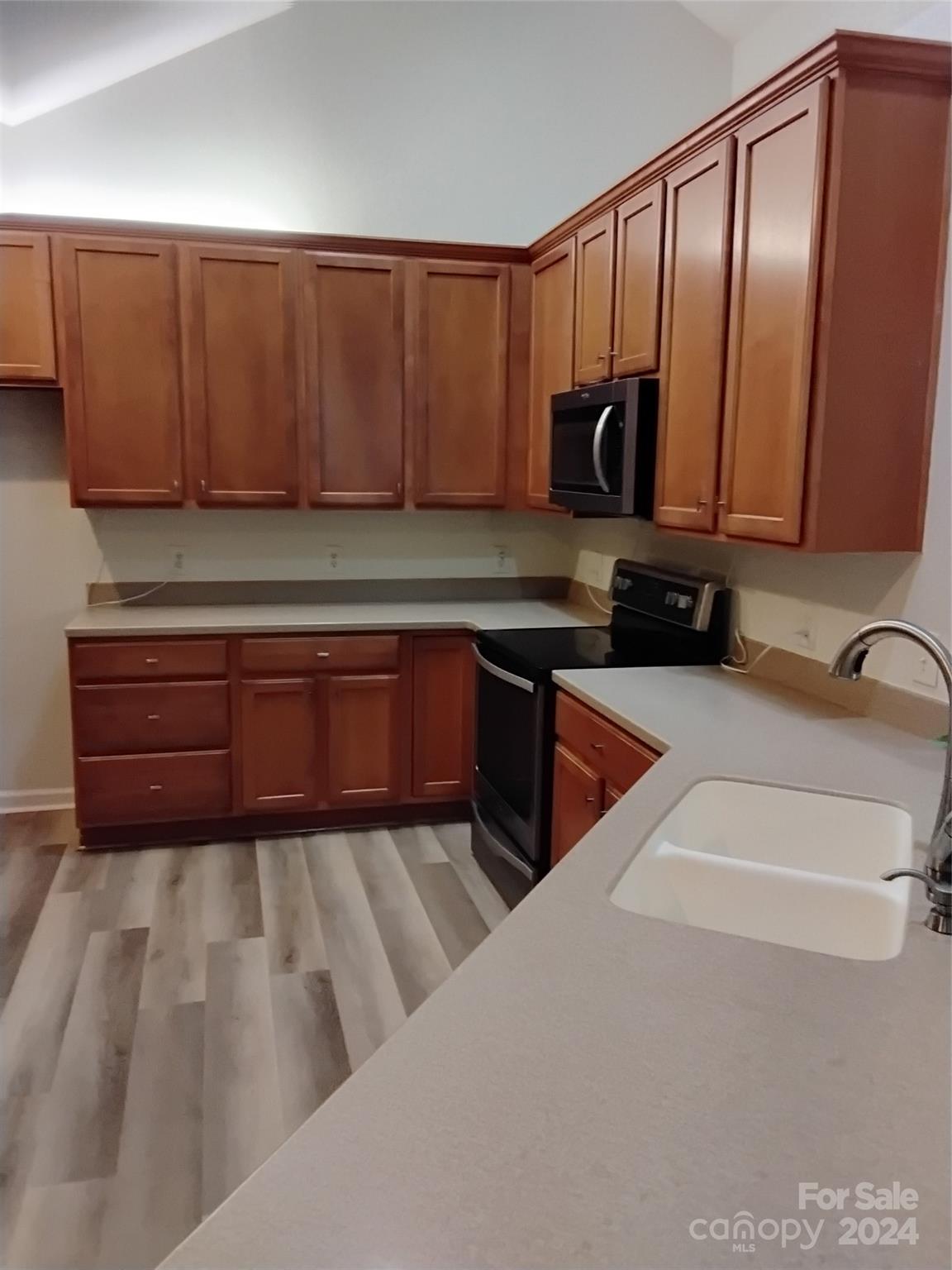 817 Ledgestone Court Fort Mill, SC 29708 - Photo 9 of 36 a kitchen with stainless steel appliances granite countertop a sink dishwasher stove and cabinets with wooden floor