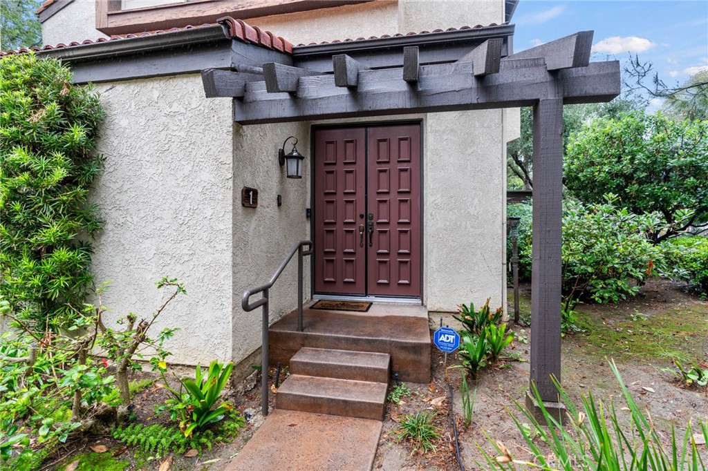 5757 Owensmouth Avenue, Unit 1 Woodland Hills, CA 91367 - Photo 1 of 42 a front view of a house with a garden