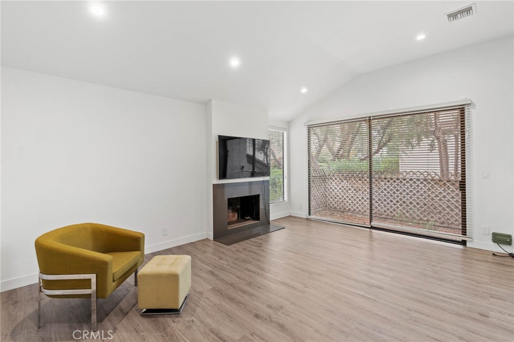 5757 Owensmouth Avenue, Unit 1 Woodland Hills, CA 91367 - Photo 11 of 42 a living room with furniture and a fireplace