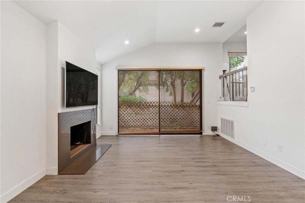 5757 Owensmouth Avenue, Unit 1 Woodland Hills, CA 91367 - Photo 12 of 42 a view of a livingroom with wooden floor and a fireplace
