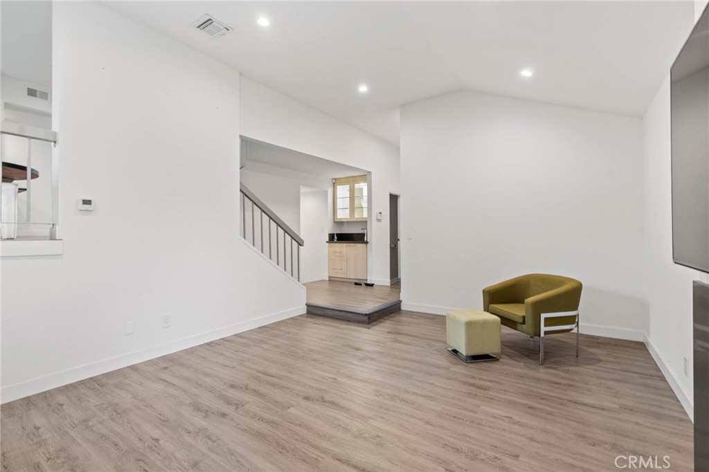 5757 Owensmouth Avenue, Unit 1 Woodland Hills, CA 91367 - Photo 13 of 42 a view of a livingroom with furniture and wooden floor