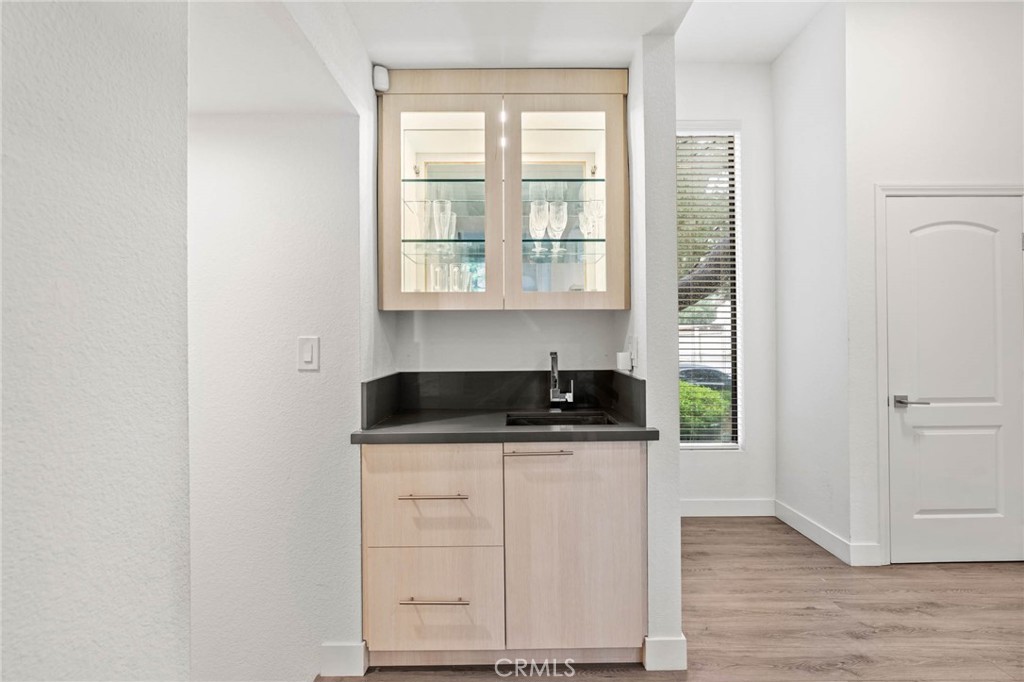 5757 Owensmouth Avenue, Unit 1 Woodland Hills, CA 91367 - Photo 14 of 42 a kitchen with granite countertop a stove a sink and a microwave