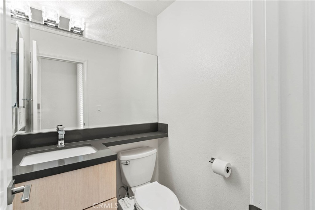 5757 Owensmouth Avenue, Unit 1 Woodland Hills, CA 91367 - Photo 15 of 42 a bathroom with a granite countertop sink and a mirror