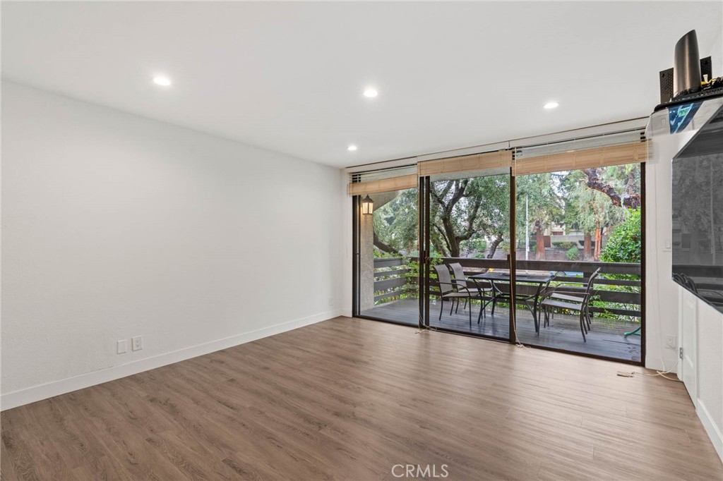 5757 Owensmouth Avenue, Unit 1 Woodland Hills, CA 91367 - Photo 17 of 42 wooden floor in an empty room with a window