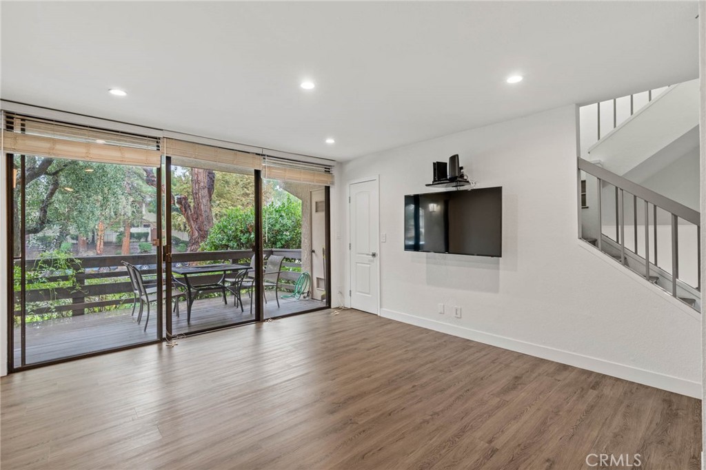 5757 Owensmouth Avenue, Unit 1 Woodland Hills, CA 91367 - Photo 18 of 42 wooden floor in an empty room with a window