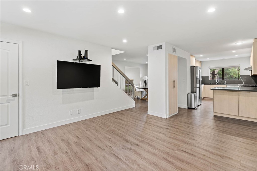 5757 Owensmouth Avenue, Unit 1 Woodland Hills, CA 91367 - Photo 20 of 42 a view of a big room with wooden floor and windows