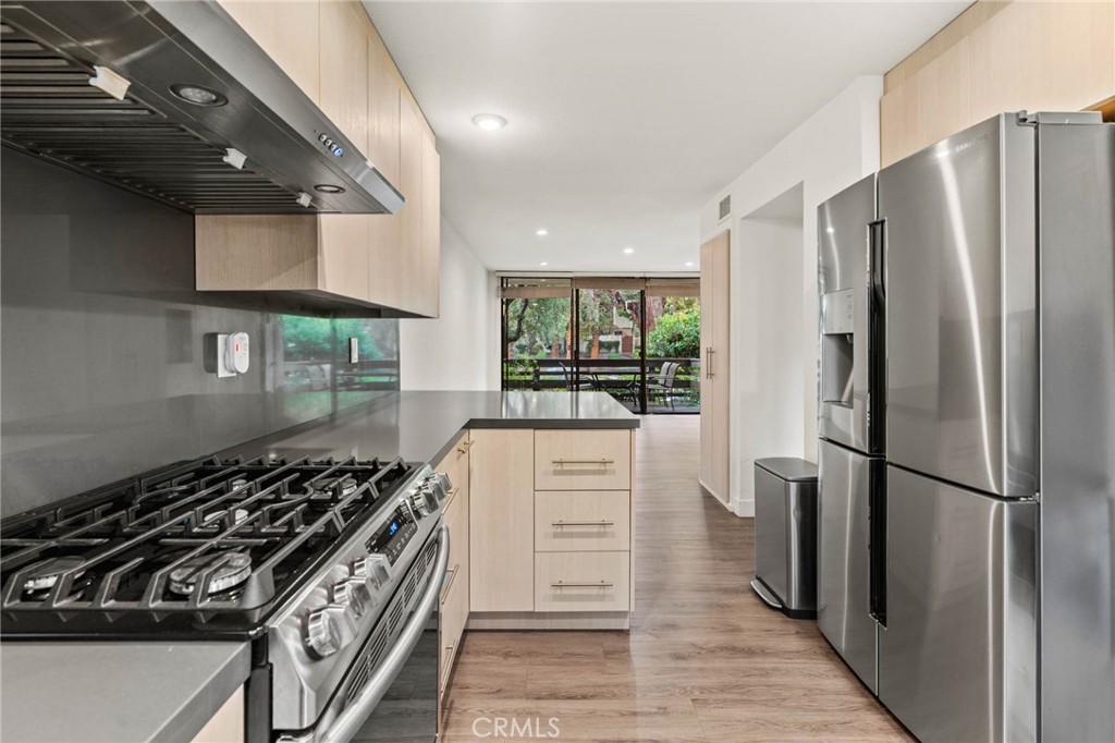 5757 Owensmouth Avenue, Unit 1 Woodland Hills, CA 91367 - Photo 25 of 42 a kitchen with stainless steel appliances a refrigerator and a stove