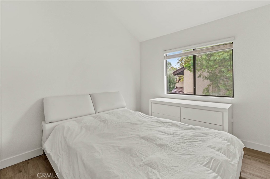 5757 Owensmouth Avenue, Unit 1 Woodland Hills, CA 91367 - Photo 29 of 42 a large white bed in a bedroom next to a window