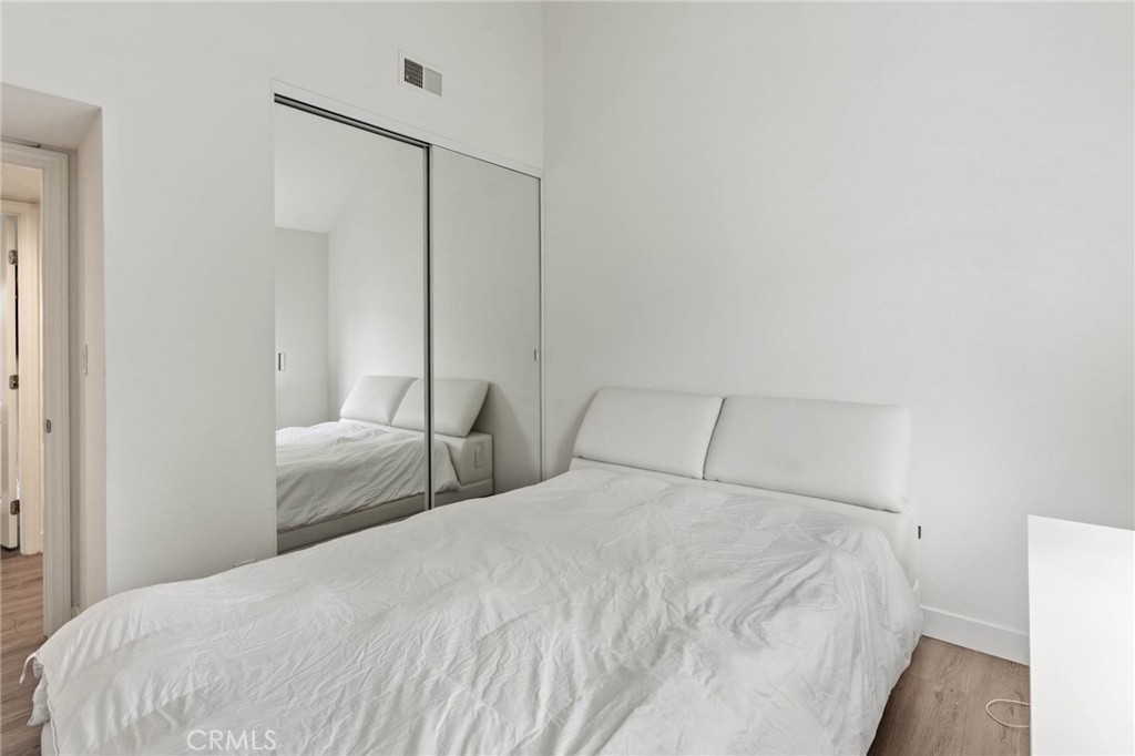 5757 Owensmouth Avenue, Unit 1 Woodland Hills, CA 91367 - Photo 30 of 42 a bedroom with a bed and a night stand