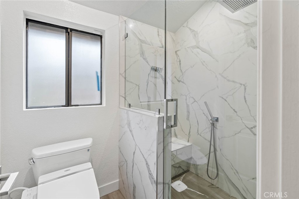 5757 Owensmouth Avenue, Unit 1 Woodland Hills, CA 91367 - Photo 37 of 42 a bathroom with a shower and toilet