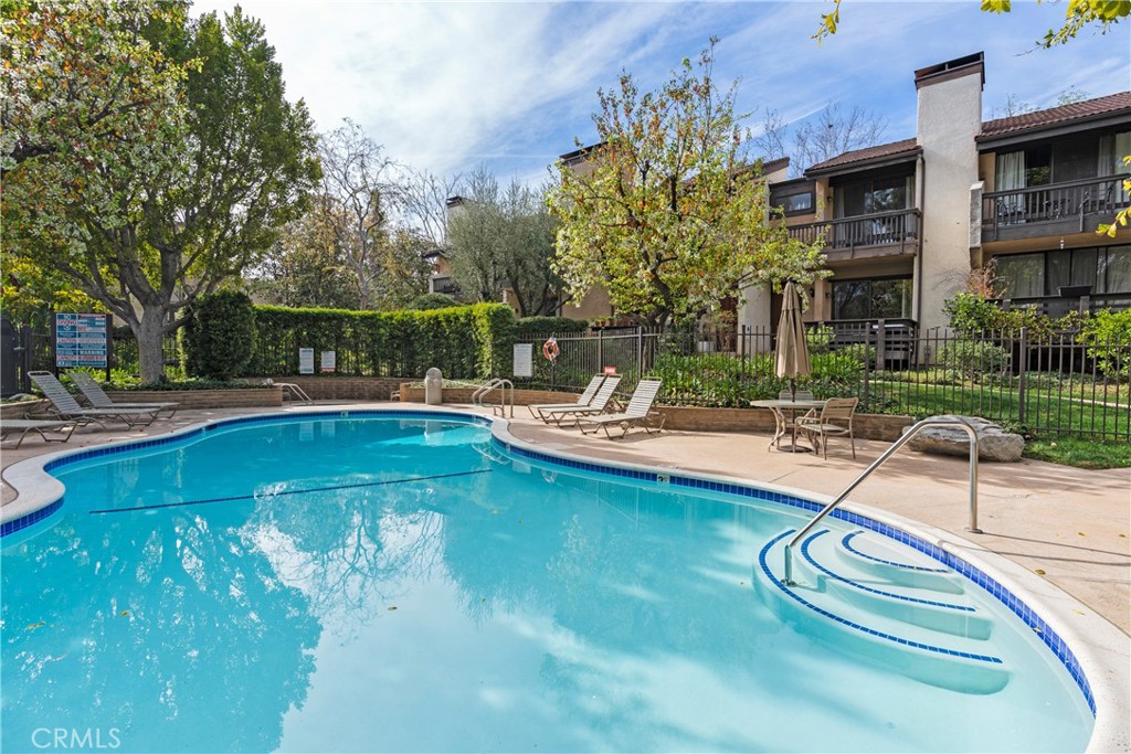 5757 Owensmouth Avenue, Unit 1 Woodland Hills, CA 91367 - Photo 4 of 42 a swimming pool with outdoor seating and yard