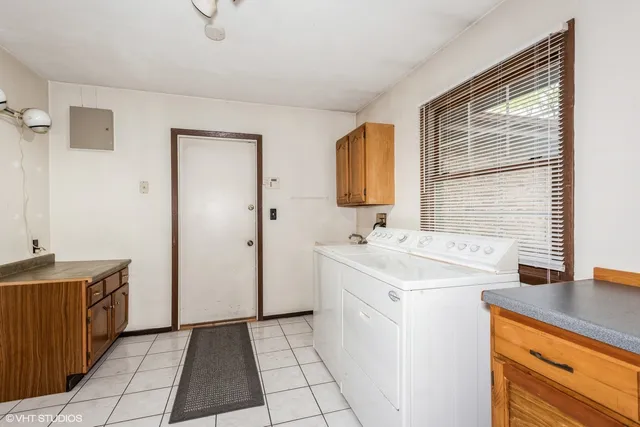 a view of a yard with wooden fence