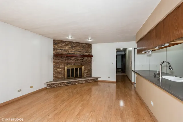 a view of a kitchen with a sink and a fireplace