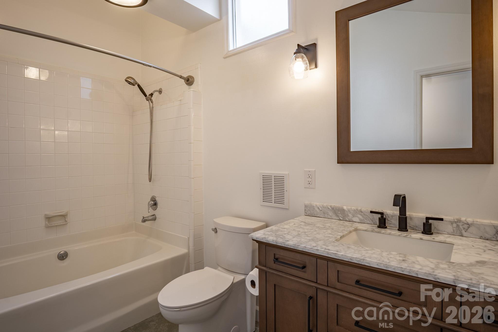 208 Island View Road Mount Holly, NC 28120 - Photo 17 of 37 a bathroom with a granite countertop sink a toilet and shower