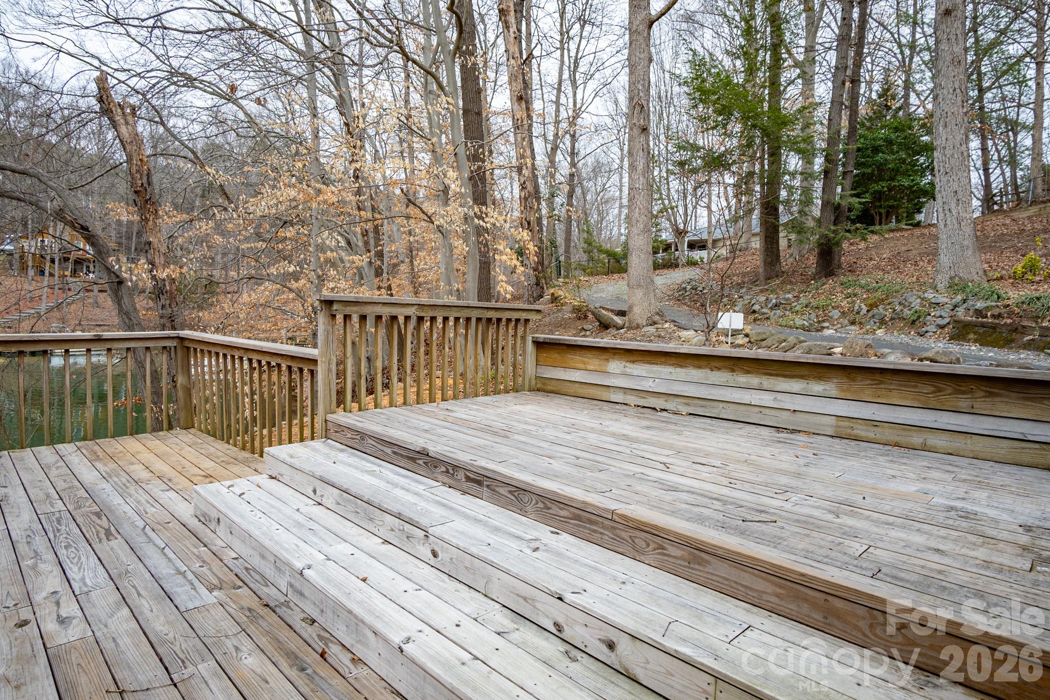 208 Island View Road Mount Holly, NC 28120 - Photo 18 of 37 a view of a wooden deck with a bench