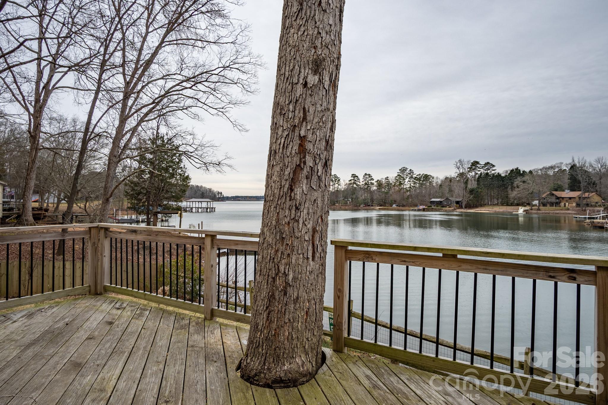 208 Island View Road Mount Holly, NC 28120 - Photo 26 of 37 a balcony with wooden floor next to a yard