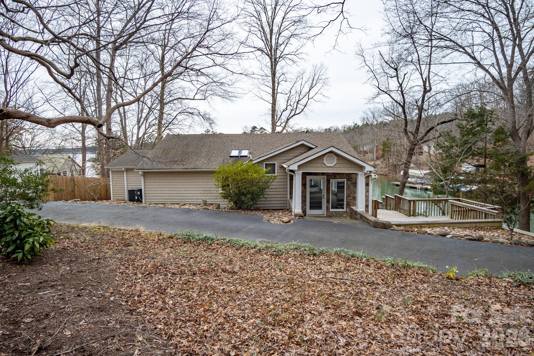 208 Island View Road Mount Holly, NC 28120 - Photo 3 of 37 a view of a house with a yard covered in the road