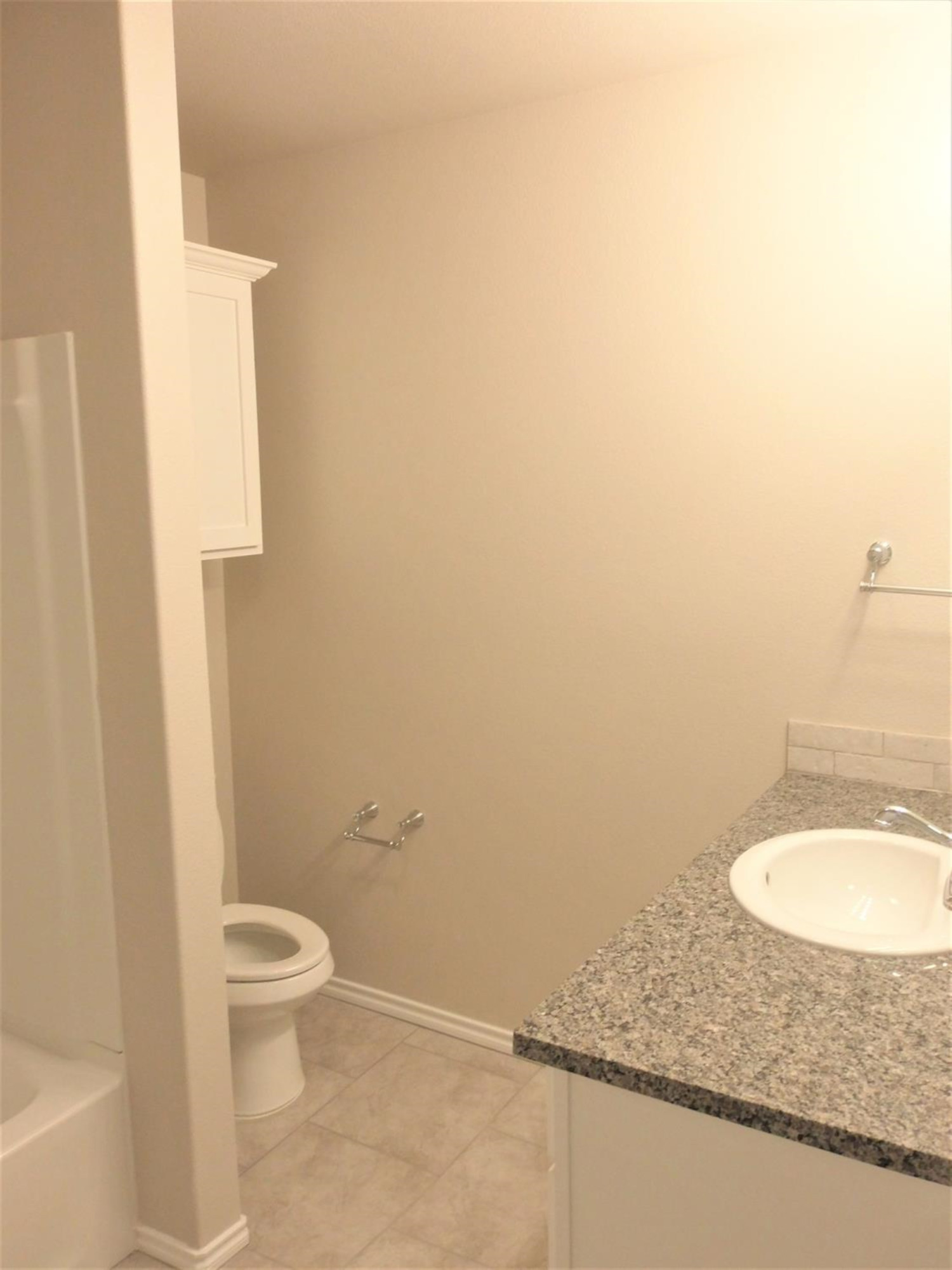 3712 Prentiss Avenue Lubbock, TX 79407 - Photo 11 of 23 a bathroom with a granite countertop toilet and a sink