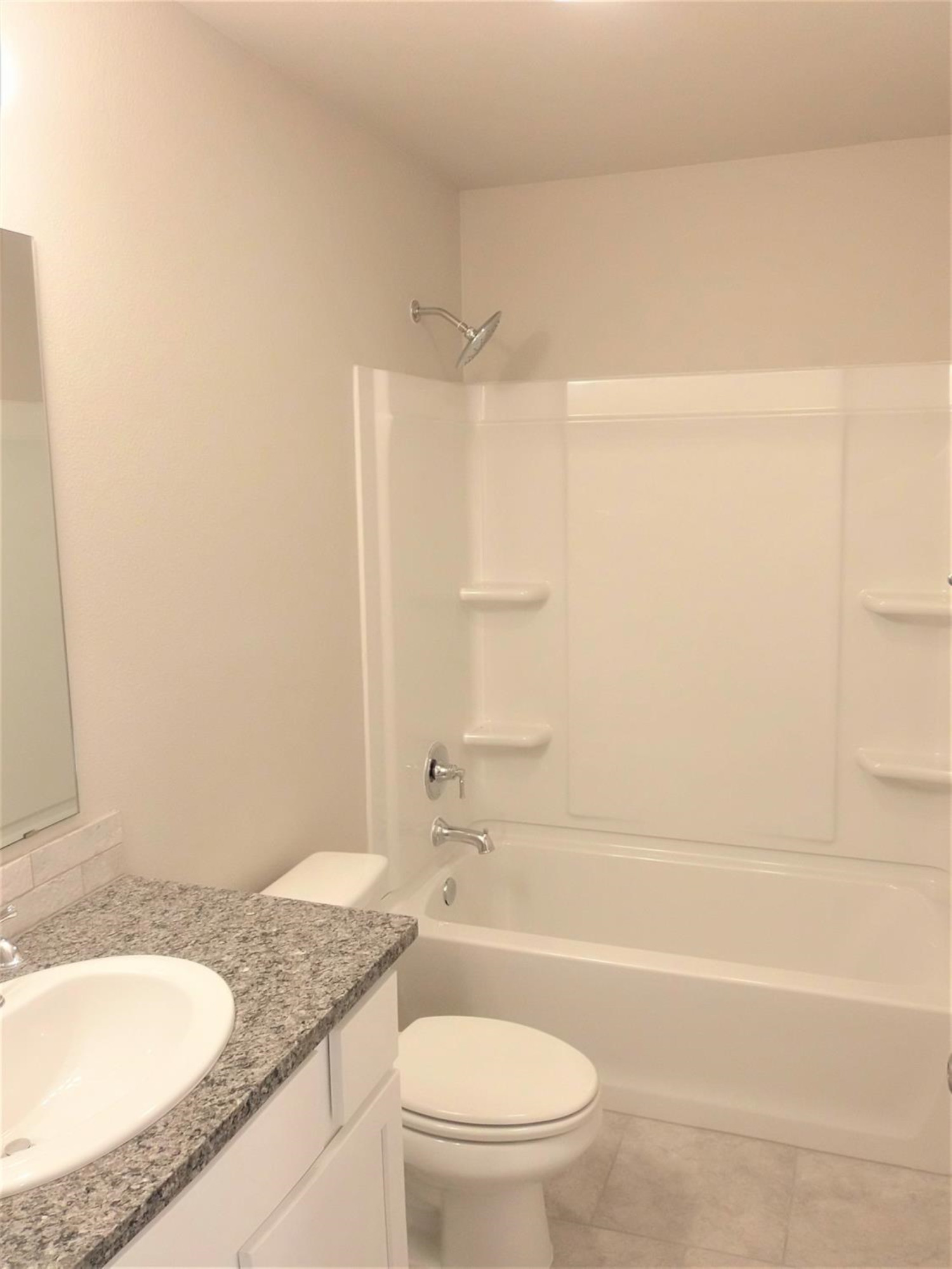 3712 Prentiss Avenue Lubbock, TX 79407 - Photo 16 of 23 a bathroom with a granite countertop bathtub sink vanity mirror and toilet