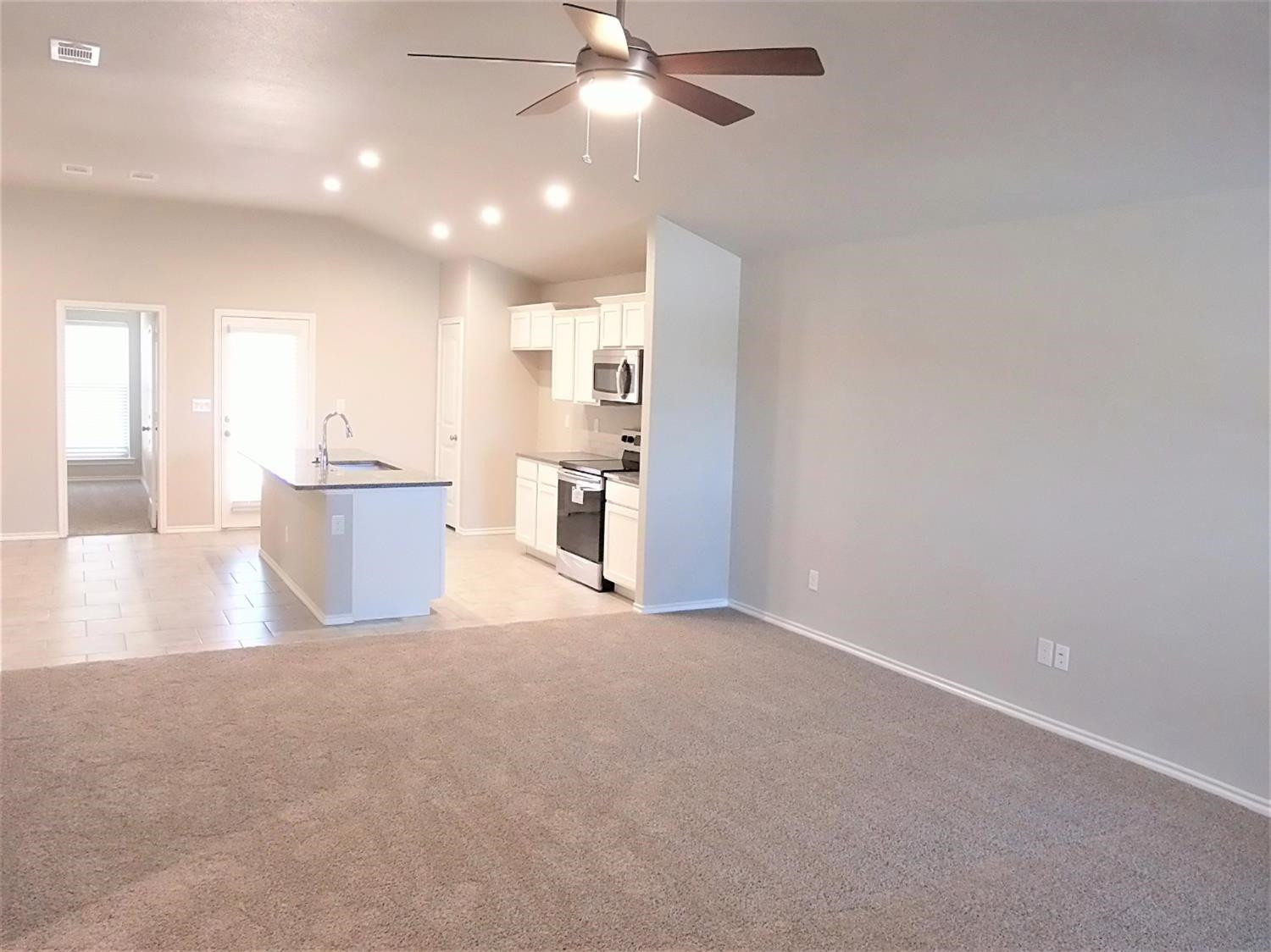 3712 Prentiss Avenue Lubbock, TX 79407 - Photo 3 of 23 a view of a kitchen with a sink and microwave